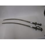 Two Indian Tulwar type swords Blades are 71cm long x 2.5cm broad and the other is 75cm long x 3cm