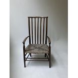 Late 20th Century stained beechwood low seat open elbow chair with rush seat (at fault)