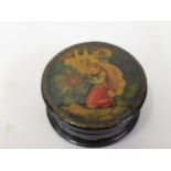 Small Russian circular lacquered box and cover decorated with a kneeling figure of a woman before