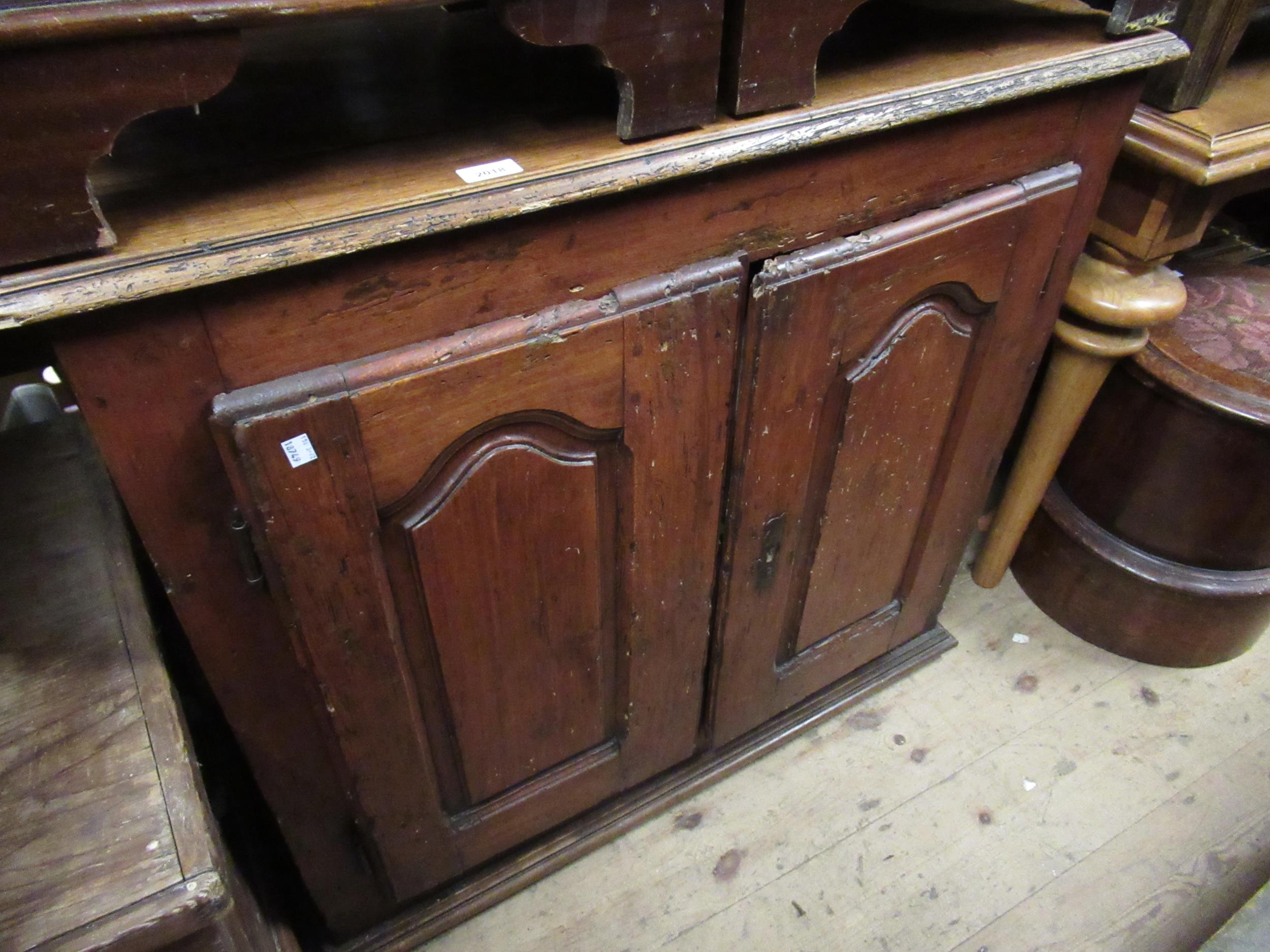 18th Century French cherry wood cupboard, the moulded top above two arch panel doors enclosing