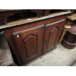 18th Century French cherry wood cupboard, the moulded top above two arch panel doors enclosing