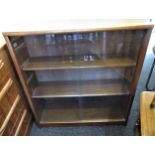 Mid 20th Century teak dwarf bookcase by Jonell with two glass sliding doors, 30ins wide x 9.5ins