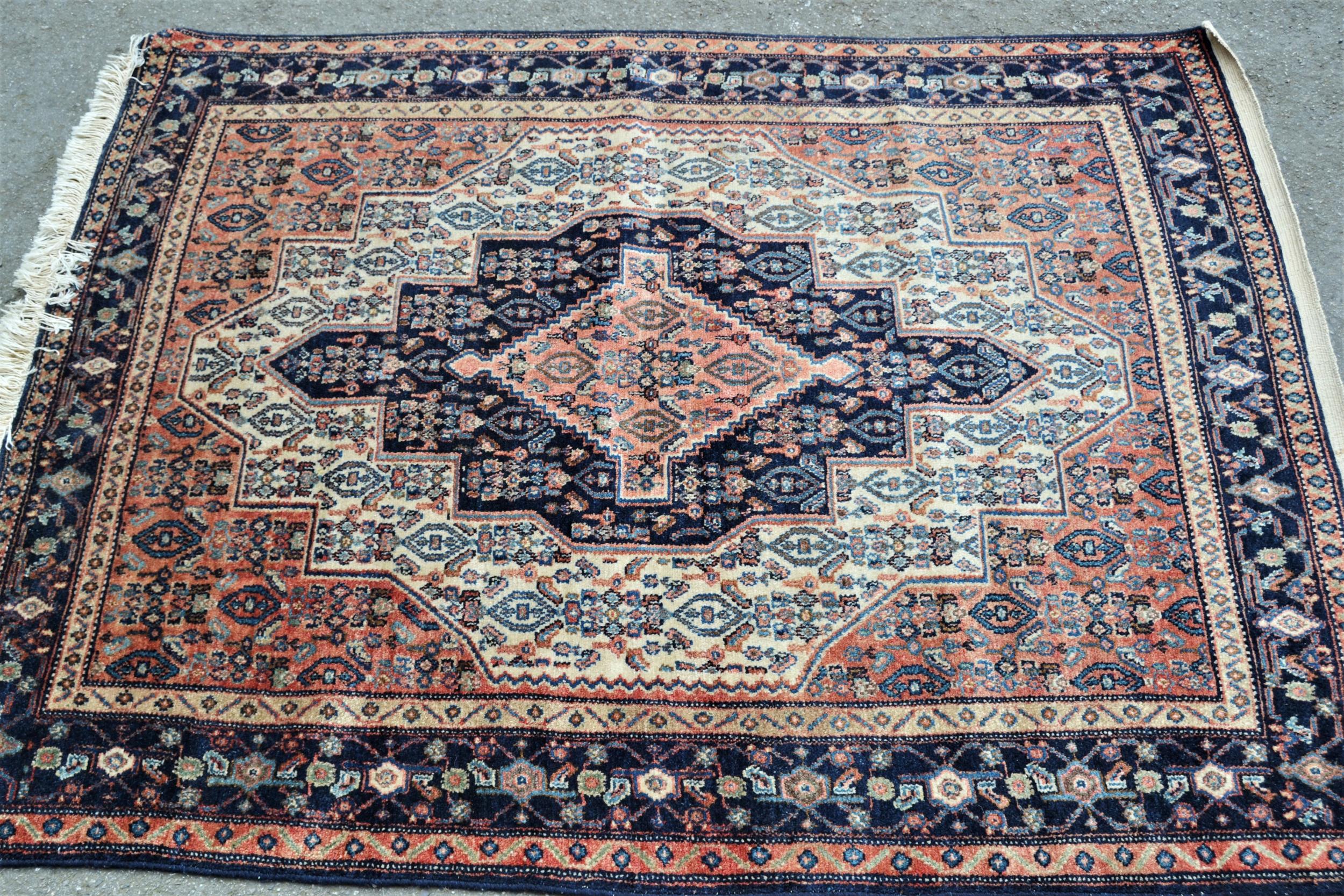 Small Hamadan rug with a medallion and all-over Herati design in shades of rose, midnight blue and