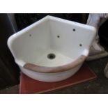 Early 20th Century porcelain wall mounted corner sink with beechwood front and original wall mounted