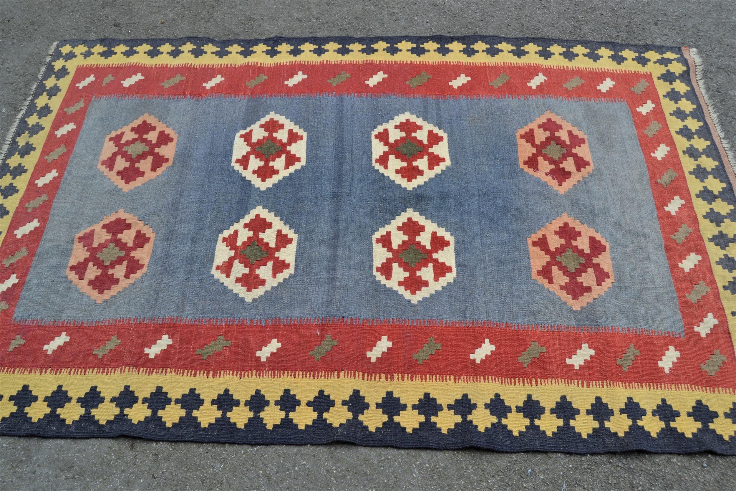 Small Kelim rug with two rows of four gols on a pale blue ground with borders, 6ft 6ins x 4ft 5ins