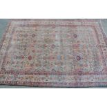 Large Tabriz carpet of all-over floral design with multiple borders (some wear), on cream ground,