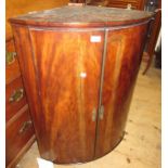 George III mahogany bow fronted two door hanging corner cabinet, 26ins wide