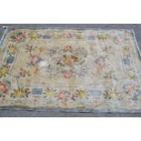 Small Chinese silk rug with an embossed medallion and floral design with borders and signature