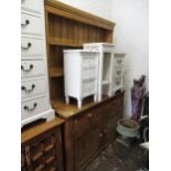 Stripped pine dresser, the boarded shelf back above two drawers and two panel doors with knob