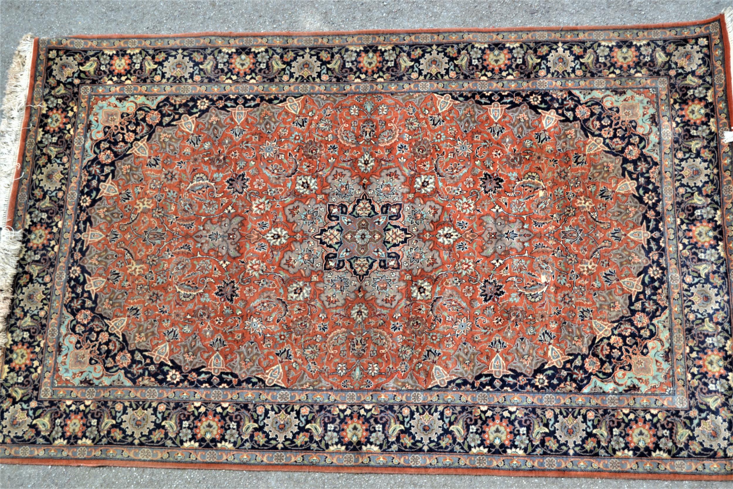 Indo Persian rug with a lobed medallion and all-over palmette design on a mid tan ground with