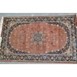 Indo Persian rug with a lobed medallion and all-over palmette design on a mid tan ground with