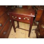 Small reproduction mahogany side table with single draw, having brass swan neck handles, on reeded