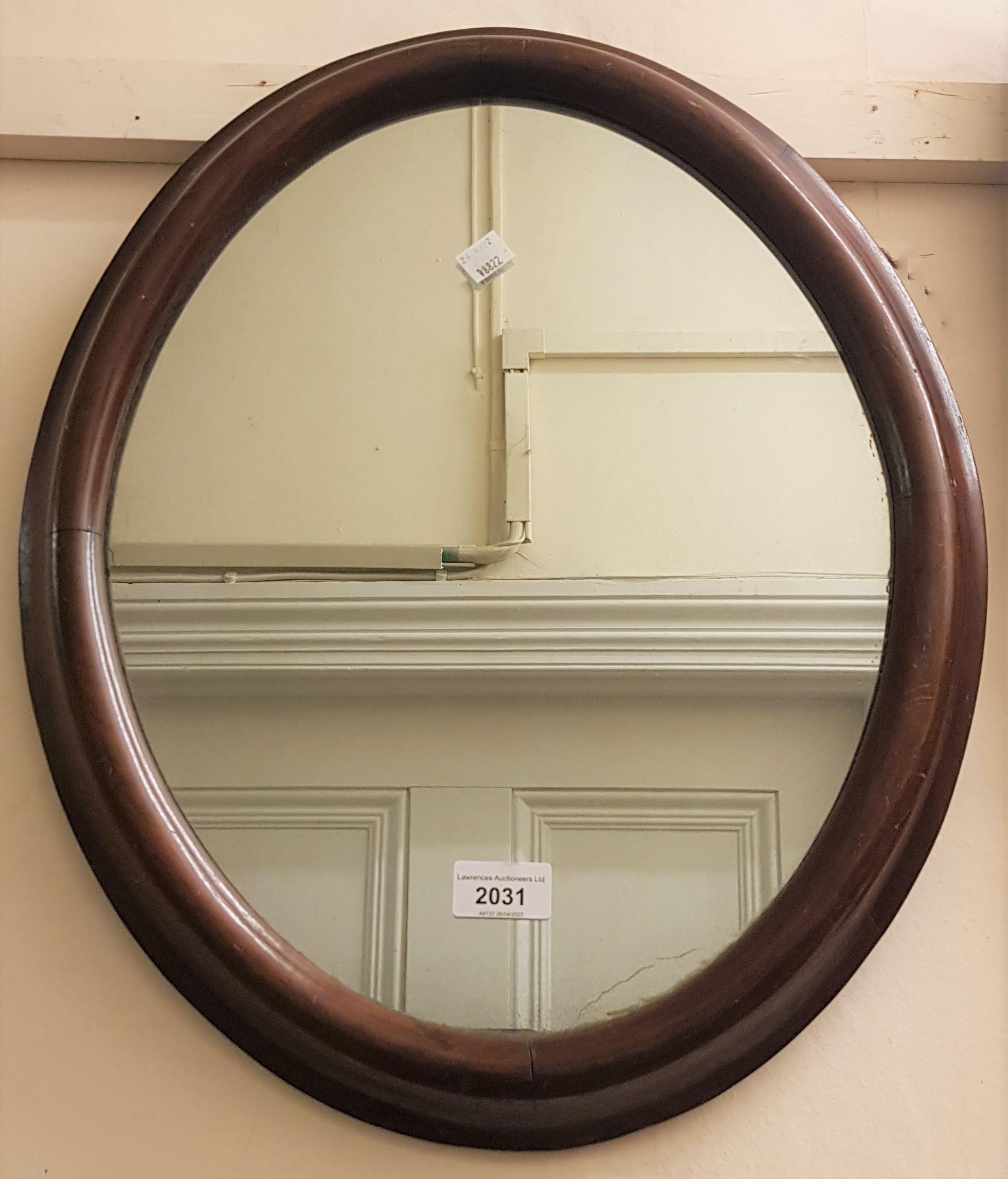 Oval walnut framed wall mirror together with a rectangular wavy edge walnut wall mirror