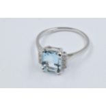 Platinum ring set rectangular aquamarine flanked by six small diamonds, the aquamarine approximately