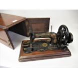 Early Singer model 12K sewing machine in a mahogany case The hand crank turns, the needle goes up