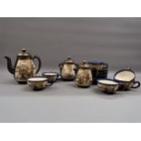 Japanese Satsuma pottery coffee service decorated with panels of figures and landscapes on a blue