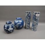Pair of Chinese blue and white cylindrical vases decorated with dragons and two prunus blossom