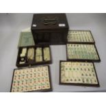 Early 20th Century Mahjong set in hardwood case with bone and bamboo counters Condition as shown