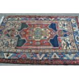 Kurdish rug with a lobed medallion design in shades of rose, green, beige and blue, 6ft 4ins x 4ft