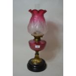 Late 19th / early 20th Century oil lamp having cranberry glass well and an etched cranberry and