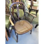 1920's Stained beechwood spindle back elbow chair with cane seat