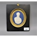 Wedgwood blue and white jasperware plaque, mounted in a gilt and ebonised frame possibly of