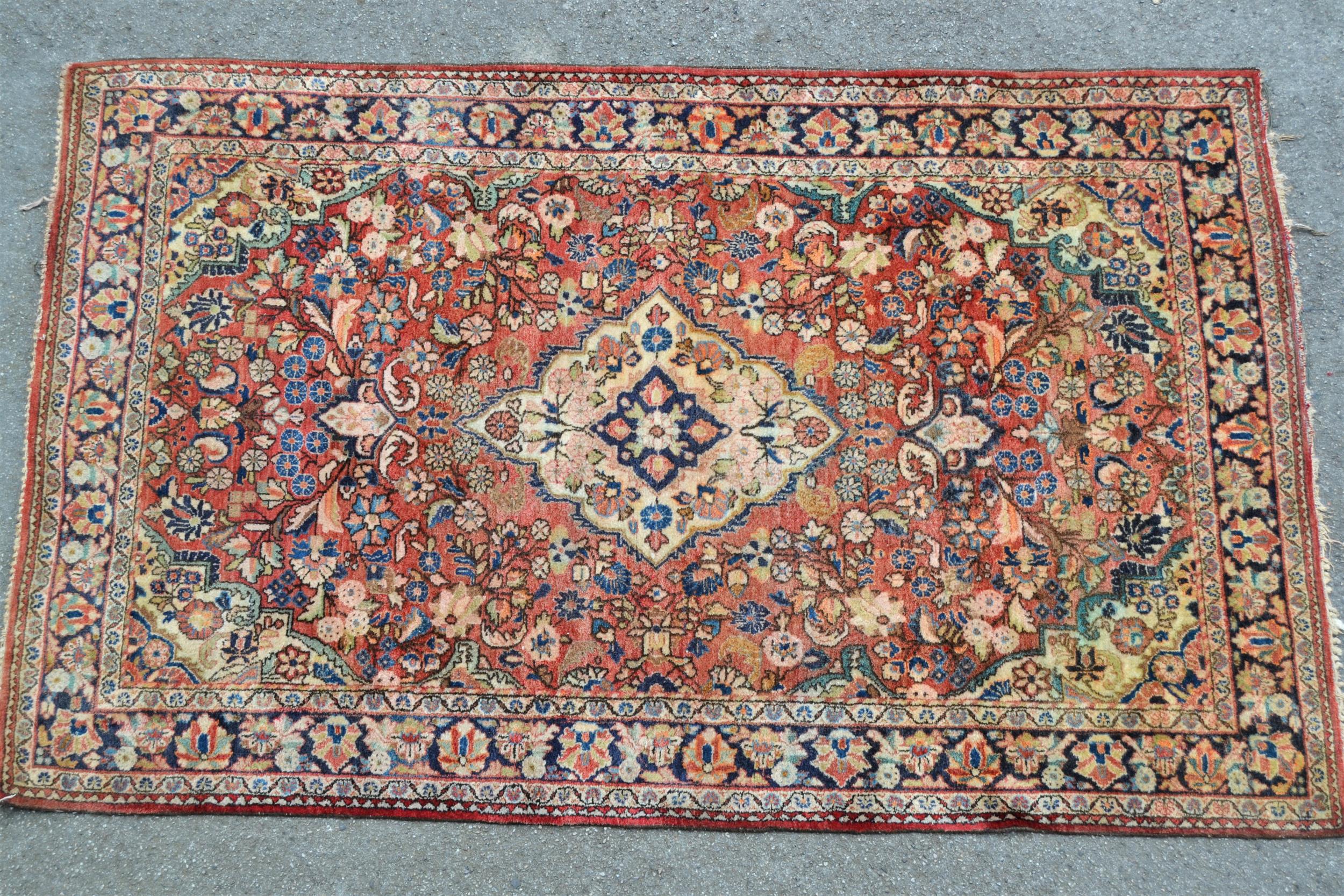 Tabriz rug with a lobed medallion and all-over floral design on a red ground with borders, 6ft