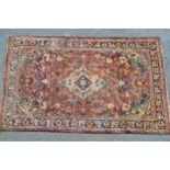 Tabriz rug with a lobed medallion and all-over floral design on a red ground with borders, 6ft