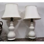 Pair of 20th Century cream glazed pottery baluster form table lamps with gilt metal mounts Lampshade