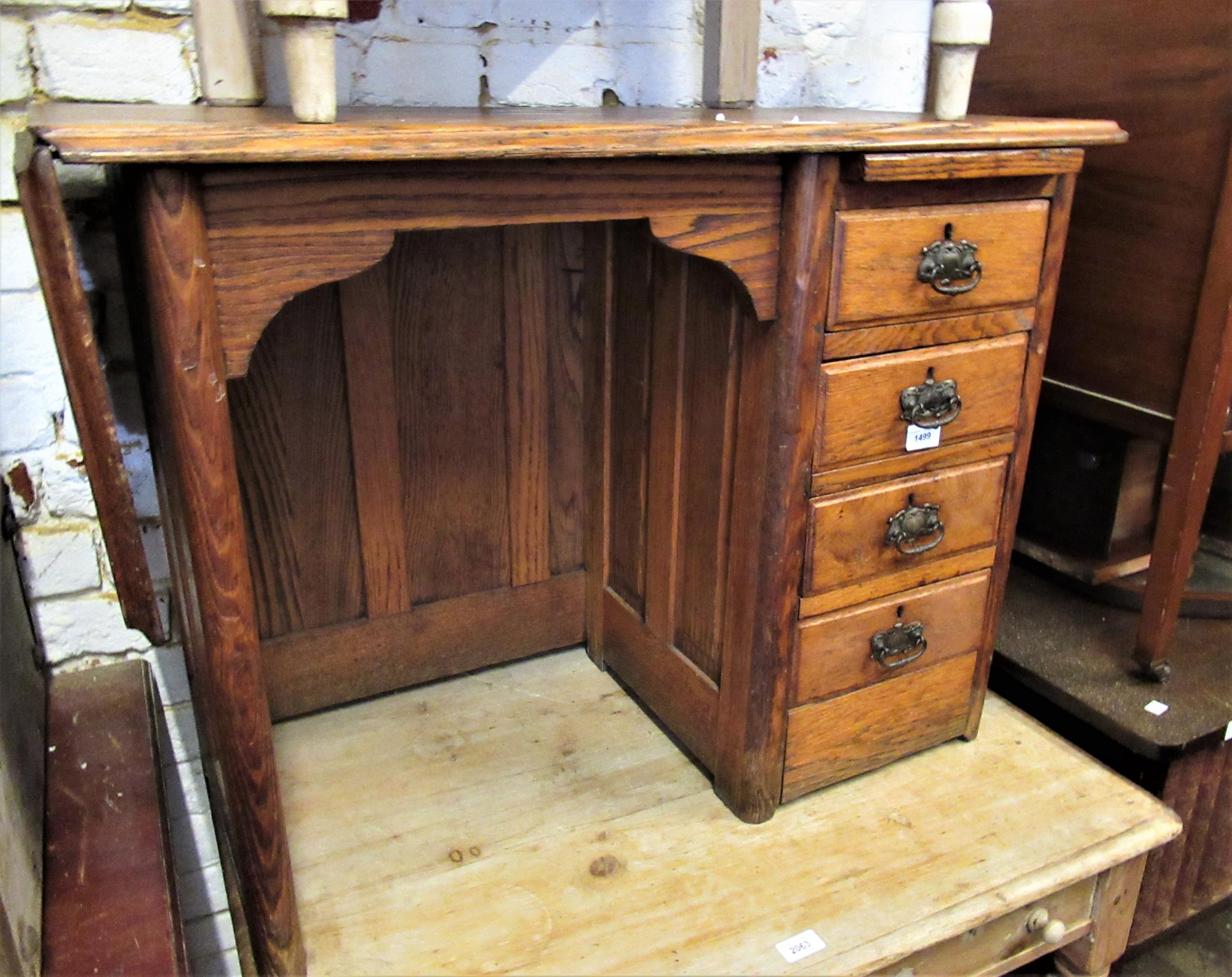 Early 20th Century child's elm single pedestal desk with drop flap, 34.5ins wide x 17ins deep x 25.