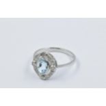 Platinum ring set oval aquamarine surrounded by brilliant cut diamonds This is a modern ring in '