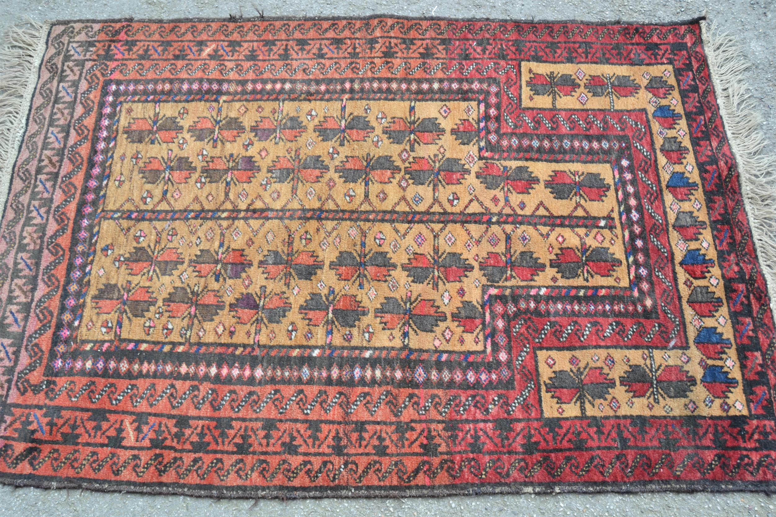 Small Belouch prayer rug with a beige field, all-over stylised flowerhead design and red ground