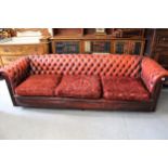 20th Century red leather upholstered Chesterfield three seat sofa, with pair of matching