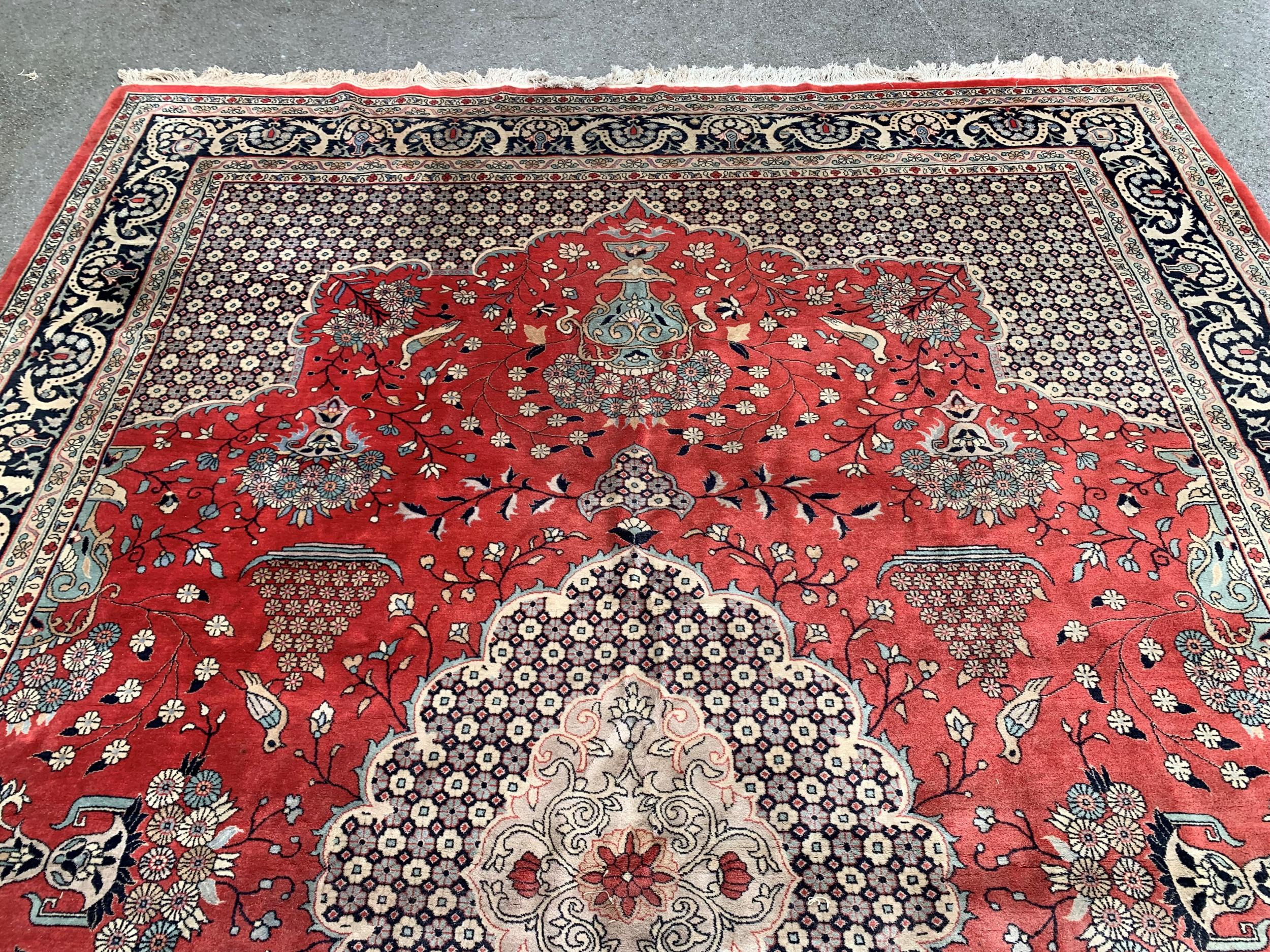 Large Indo Persian carpet with a medallion and vase design on a salmon ground with corner designs - Image 2 of 5