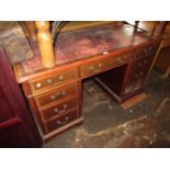 Reproduction mahogany pedestal desk having red leather inset top (at fault) above an arrangement
