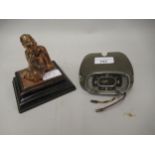 Smiths car clock in metal dashboard mount and a copper cast ornament of a seated figure, on ebonised