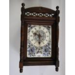 Late 19th Century Continental walnut mantel clock, the porcelain dial painted with flowers, with a