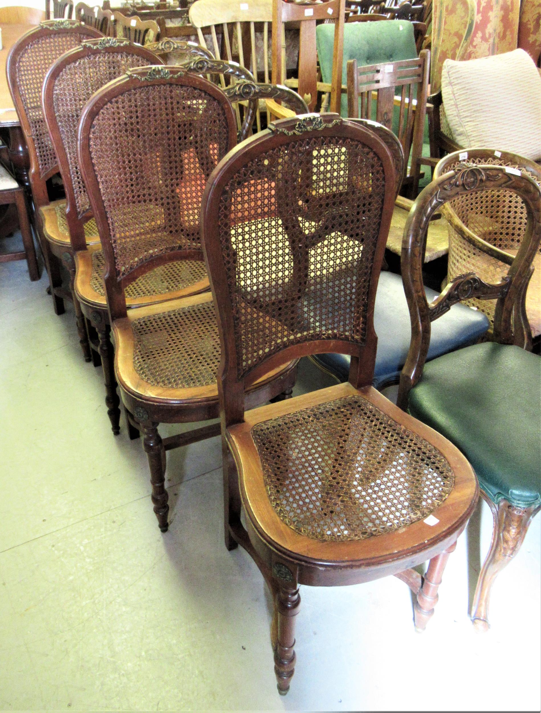 Set of four late 19th / early 20th Century French walnut salon chairs with caned back and seats,