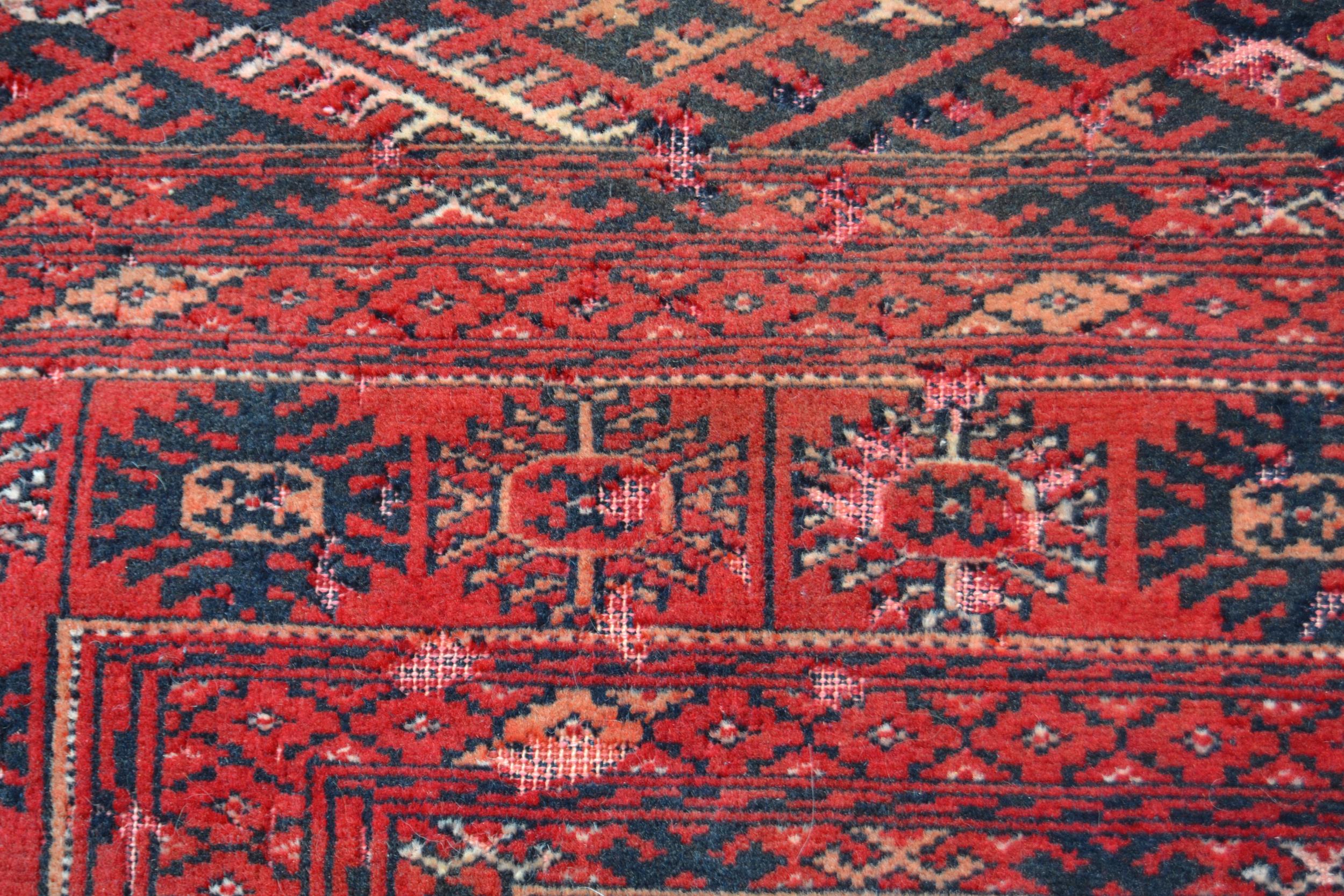 Small Turkoman rug with three rows of twelve gols on a wine ground with multiple borders, 5ft - Image 2 of 3