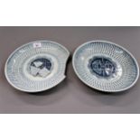 Pair of Chinese circular shallow dishes with blue and white decoration, 10.25ins diameter (one at