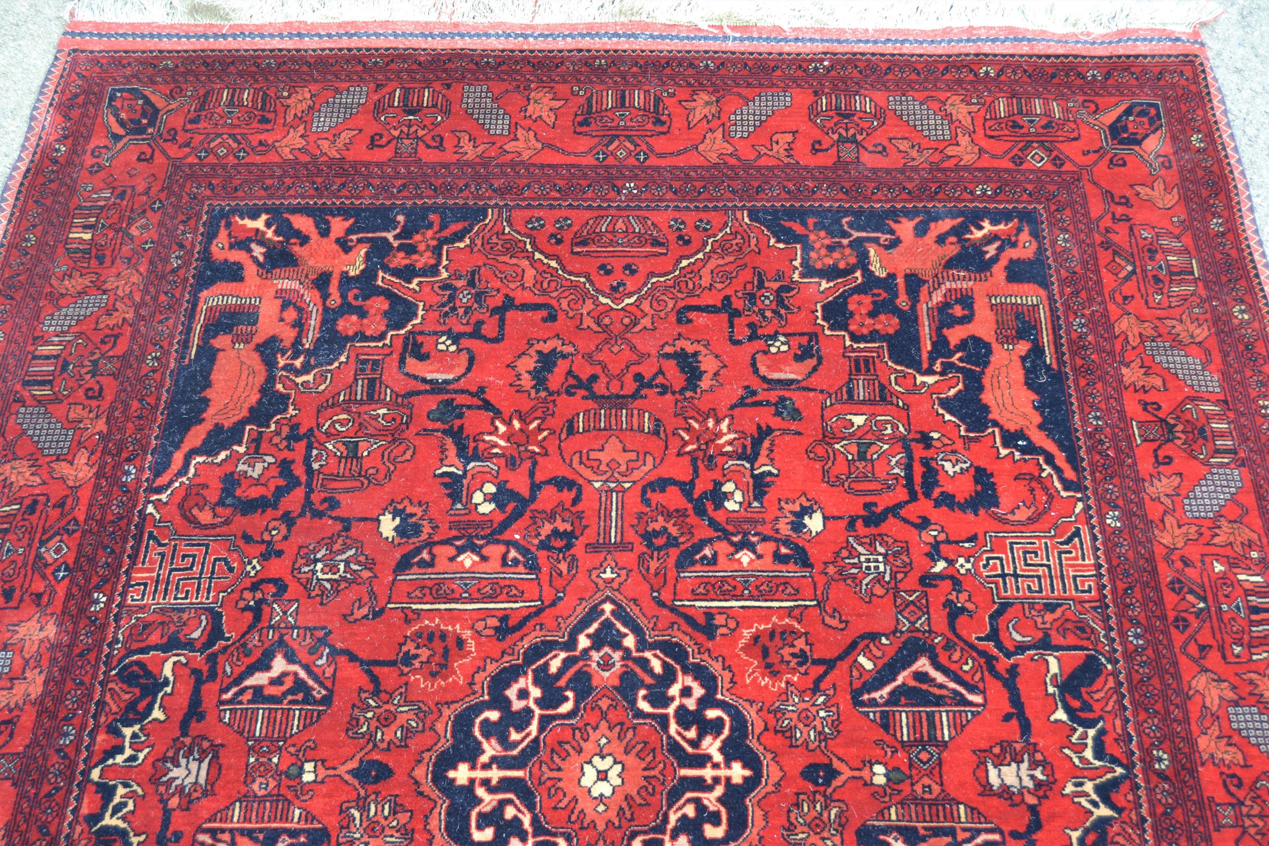 Afghan rug with a medallion and all-over stylised design, corner designs and borders, 6ft 4ins x 5ft - Image 2 of 4