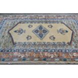 Indo Persian rug with centre medallions and multiple borders on a beige ground, approximately