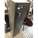 Grey steel gun cabinet with two keys