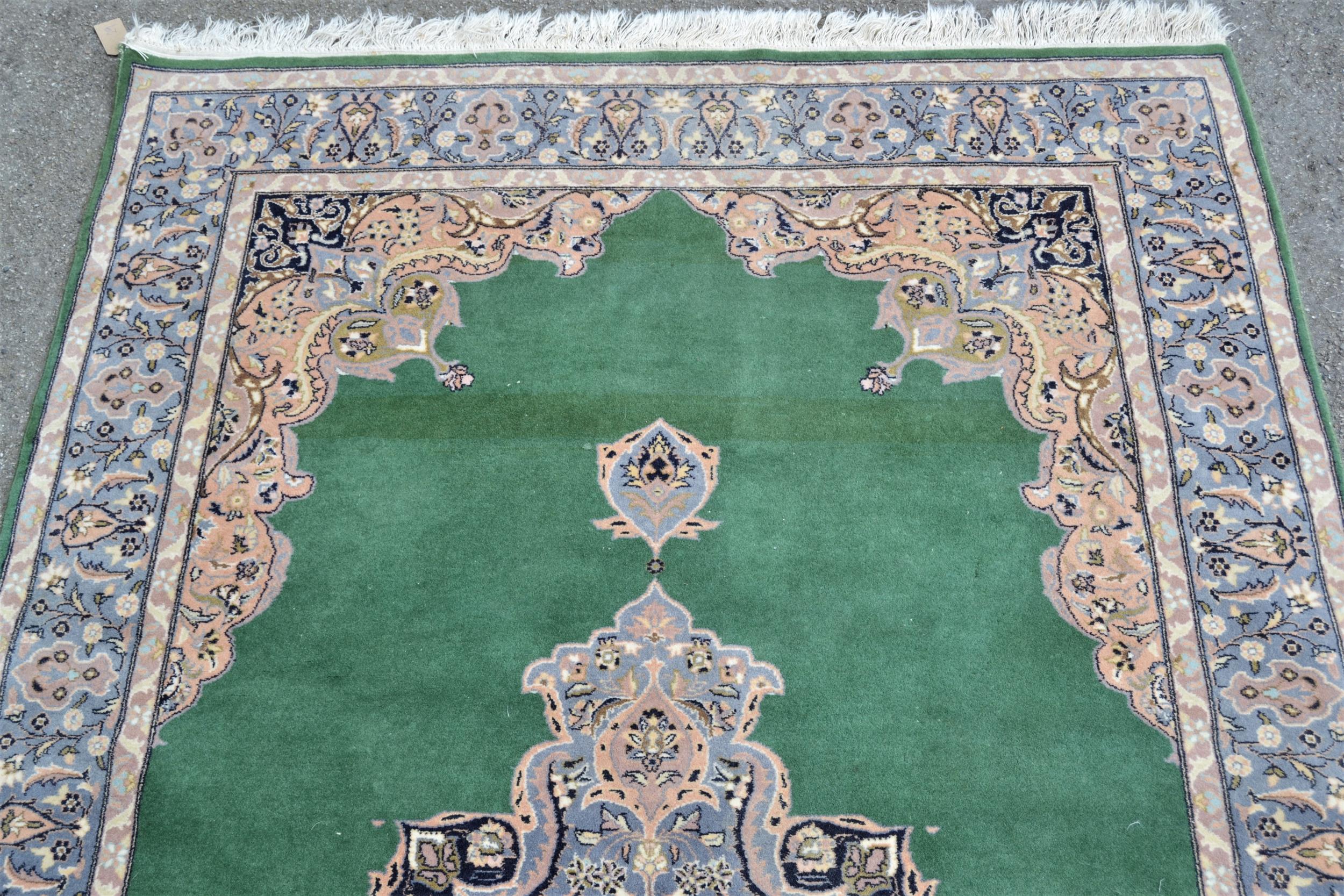 Indo Persian rug with central medallion and multiple borders on green ground, 88ins x 54ins Some - Image 2 of 4