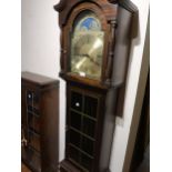 Modern mahogany grandfather clock, having brass dial with moonphase and Roman numerals, pendulum