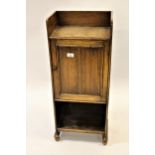 1930's Oak floorstanding smoker's cabinet / bookcase with a single panel door enclosing a fitted