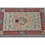 Isfahan part silk rug with a medallion, pictorial and all-over floral design on an ivory ground with