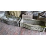 Pair of 20th Century weathered cast concrete serpentine fronted planters decorated with cherubs