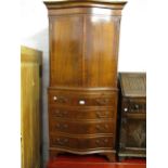 Reproduction mahogany serpentine fronted cocktail cabinet with two panel doors above a pull-out