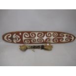 Oval native carved and painted shield, 38ins x 6.5ins together with a native tribal war club